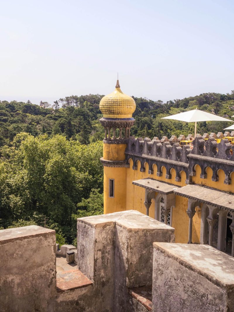 The yellow domed tower of the Pena Palace above the woods of Sintra